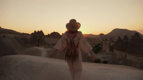 Beautiful Woman Tourist Raises Her Hands Up Rejoicing in the Travel and Sunset