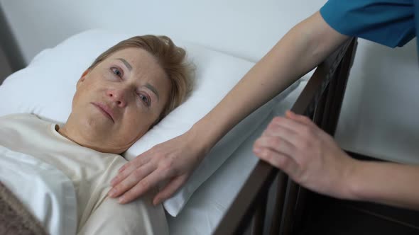 Kind Medic Stroking Old Female Shoulder, Senior Patient Lying in Sickbed, Rehab