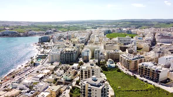 Vibrant vacation seacoast town of St. Paul Bay in Malta, aerial view