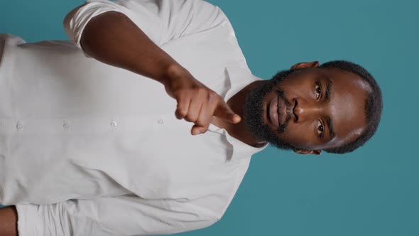 Vertical Video Portrait of Male Model Showing Silence Sign in Front of Camera