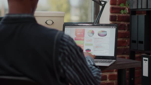 Sales Assistant Planning Business Charts on Digital Laptop