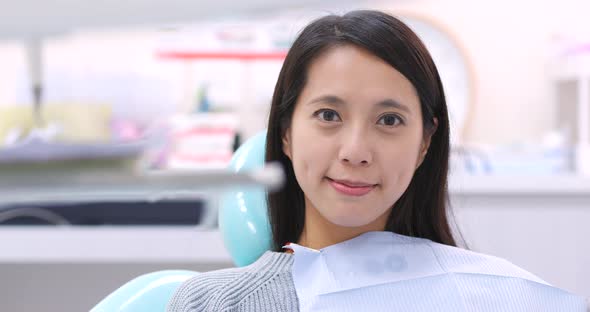 Woman dentist working at her patients teeth