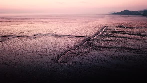 Low tide aerial view on foreshore at sunset.