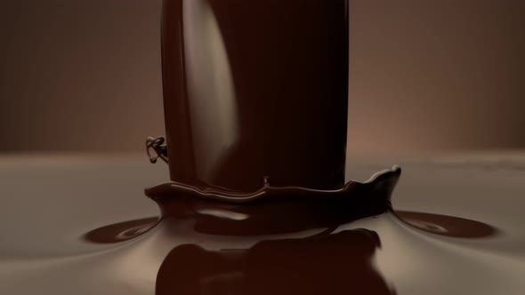 Super Slow Motion Shot of Pouring Melted Chocolate on Brown Gradient Background at 1000 Fps