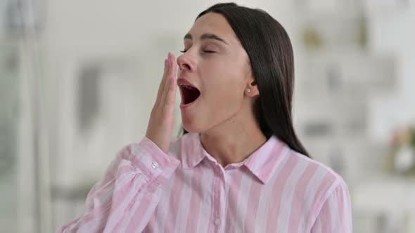 Portrait of Sleepy Young Latin Woman Yawning