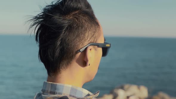 Young Nepali man looking out to sea contemplating