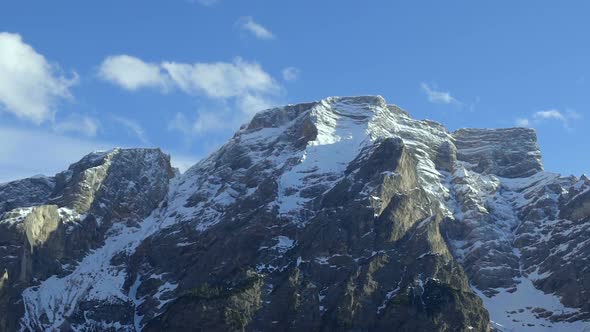 Majestic and Inaccessible Mountain Peaks With Glacier Under Clear Blue Sky