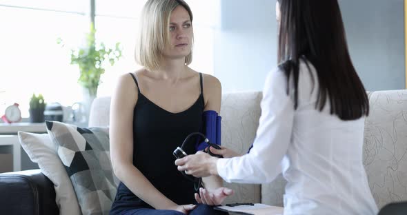 Doctor Measures Blood Pressure of Patient at Home Closeup