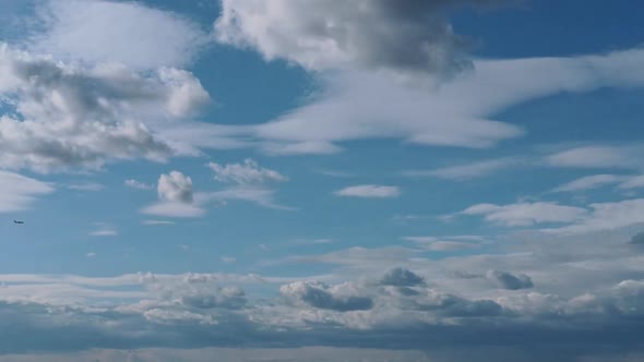 Light cumulus clouds on a blue sky turning into dark, time-lapse