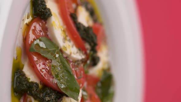 Vertical video: Mozzarella with tomato in a plate