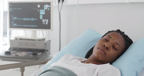 Portrait of Afroamerican Female Patient Having Heart Failure in Hospital Bed
