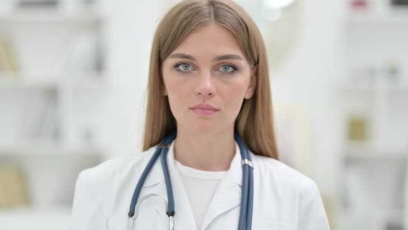 Portrait of Serious Young Doctor Looking at the Camera 