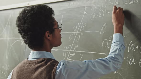 Smart Mixed-Race Student Solving Geometry Problem at Blackboard