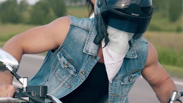 Close View Man Takes Off Black Helmet and White Sling