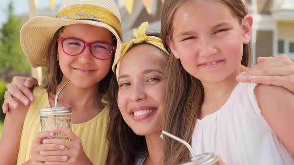 Close Up Of Mom With Daughters On Summer Day