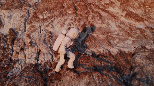 the Astronaut Climbs the Rock with Difficulty and Then Stops