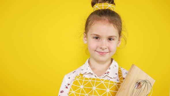 Yellow Background, Chef Girl in Yellow Apron with Kitchen Utensils