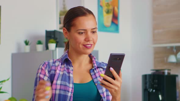 Woman Scrolling and Drinking Tea