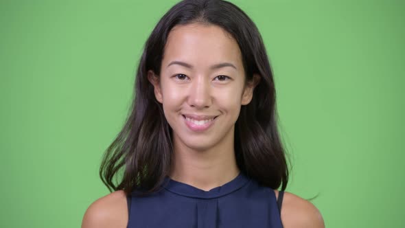 Head Shot of Young Beautiful Multiethnic Businesswoman Smiling