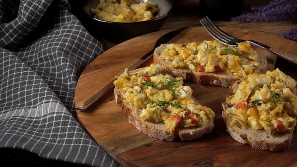 Scrambled eggs on a slice of bread.