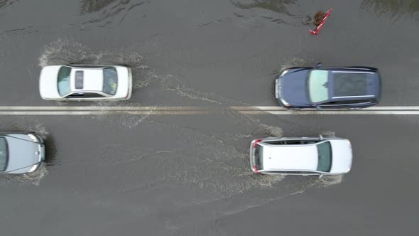 Aerial View of City Traffic with Cars Driving on Flooded Street After Heavy Rain