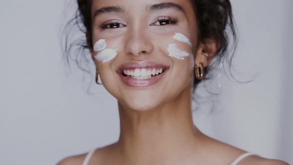 Pretty Mullato Girl Putting Cream on Her Chick and Nose Playing and Laughing