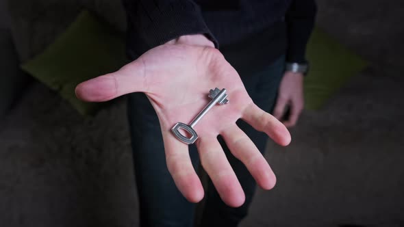 Key Hidden in the Fist of Male Hand