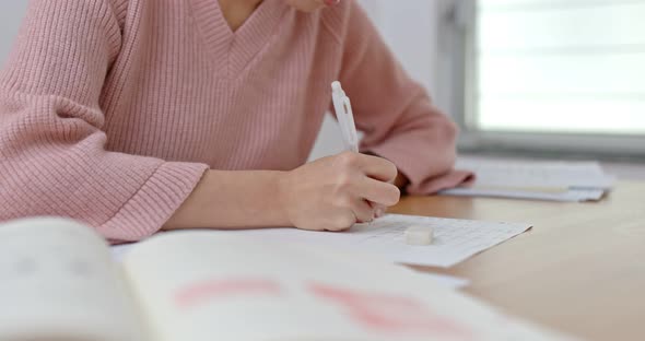 Woman write on the paper for study at home