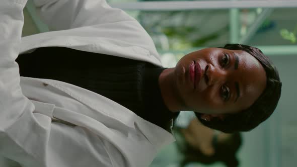 Vertical Video Closeup of African Biologist Woman Looking Into Camera