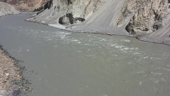 aerial drone panning left over the Indus River Valley as rapids flow fast through the gorge in Skard