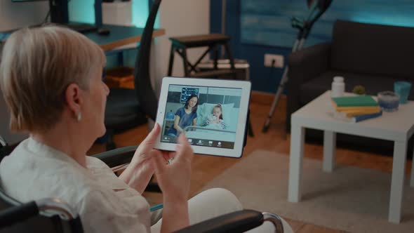Elder Person in Wheelchair Holding Tablet with Online Video Call