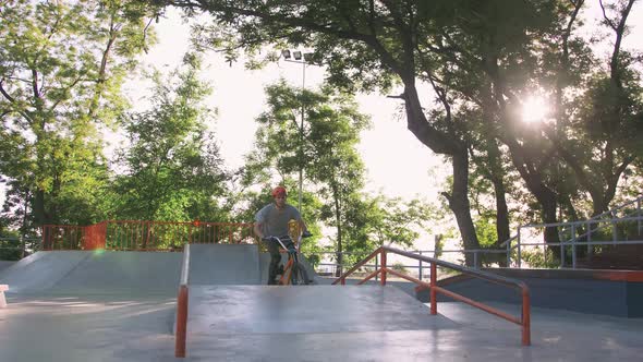 BMX Rider Doing Tricks in Cocncrete Skatepark Slow Motion