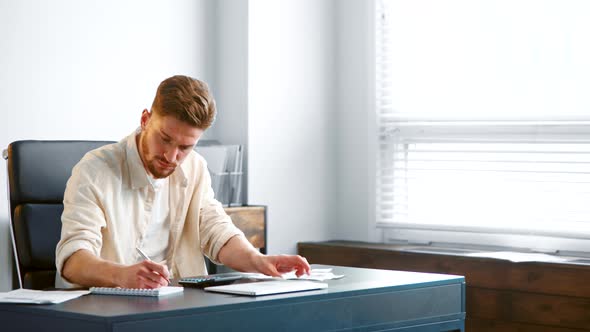 Bearded accountant sums up unexpected expenses