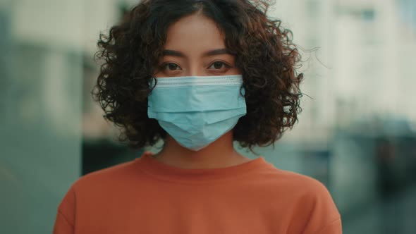 Close up of Young Attractive Indian woman wearing a medical mask