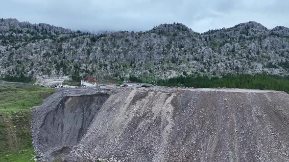 Heavy machinery drills tunnel through the mountain aerial view 4 K