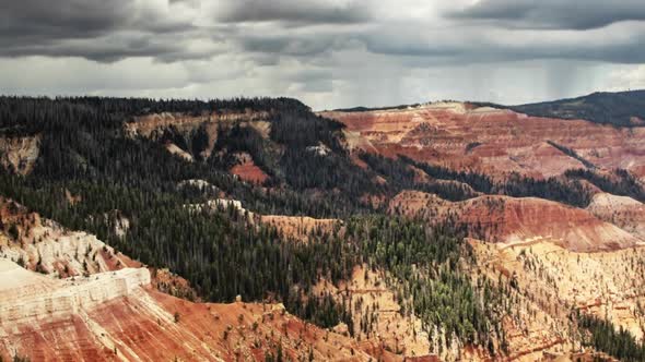 Time lapse of a red rock canyon then ZOOMING OUT to reveal a wide angle scene; dramatic storm clouds