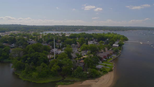 Aerial Pan of a Suburban Neighborhood in Long Island and Boats Anchored at Bay