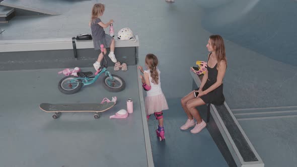 Mother with Two Kids in Indoor Skatepark