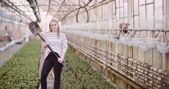 Agriculture - Successful Female Gardener Holding a Shovel