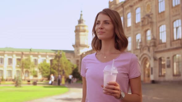 Young Woman Relish Drink Near University