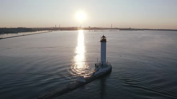 Aerial Shot of White Lighthouse Near Sea Port During Sunset Silhouette
