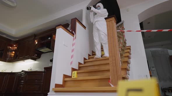 Wide Shot Portrait of Concentrated Expert Forensic Scientist in Protective Suit and Covid Face Mask