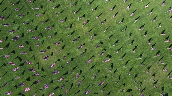 Aerial view looking down at flags starting to wave in wind