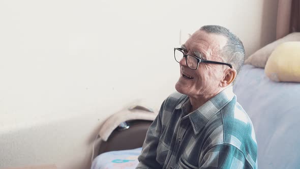 Portrait of an Elderly Man Wearing Glasses, He Laughs