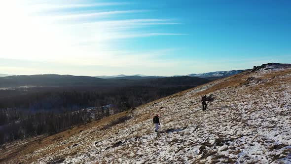 Two Hikers Climb a Snowy Mountain  Active Lifestyle Concept