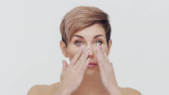 Close-up of middle aged mature woman over white background.