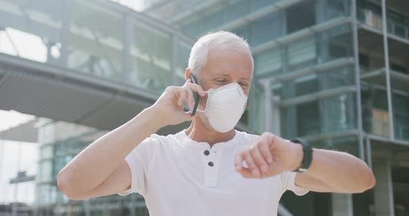 Caucasian man out and about in the street wearing on a face mask against coronavirus