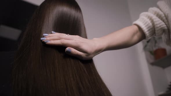 Demonstration of Smooth and Silky Hair After Straightening It with a Steampod