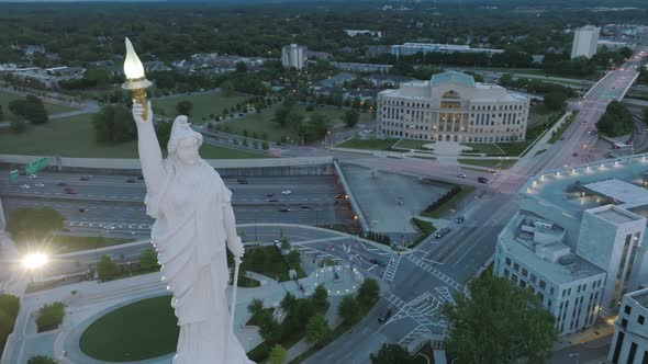 Slow close up aerial rotating footage of the statue on top of the Capitol Building in downtown Atlan