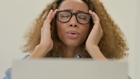 Portrait of African Woman with Headache Working on Laptop